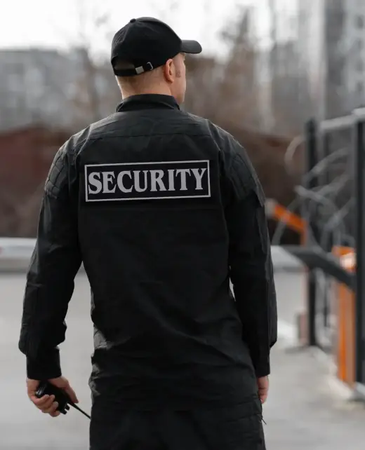 portrait-male-security-guard-with-barbed-wire-fence
